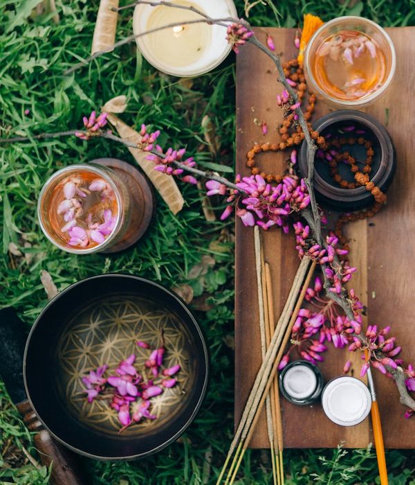 Woman in a calm yoga pose in a dark, atmospheric setting.